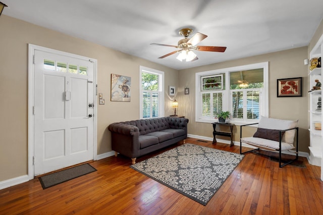 living room with ceiling fan and wood-type flooring