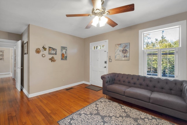 living room featuring ceiling fan and hardwood / wood-style floors