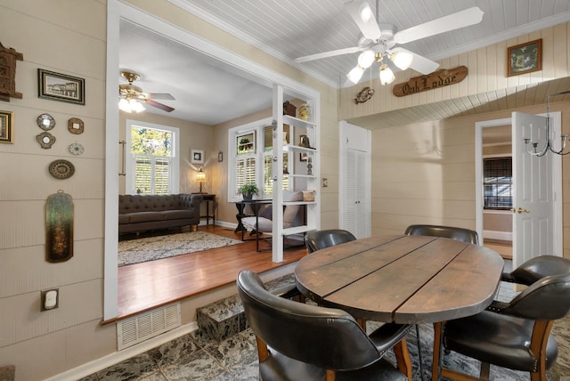 dining space featuring ceiling fan and crown molding