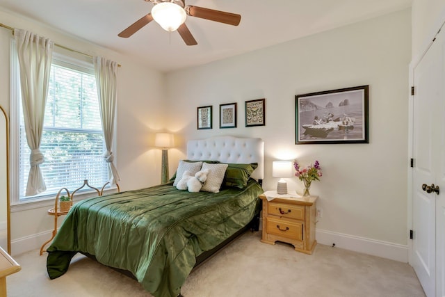 bedroom with light carpet and ceiling fan