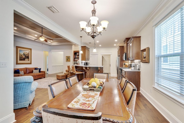 dining room featuring crown molding, ceiling fan with notable chandelier, and light wood-type flooring