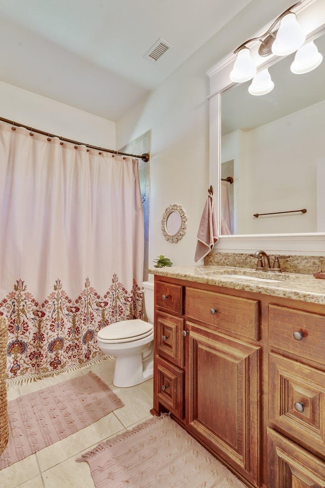 bathroom with vanity, tile patterned flooring, and toilet