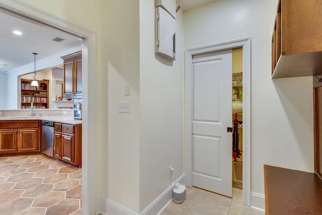 hallway with ornamental molding and sink