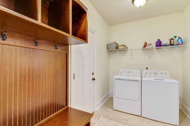 laundry area featuring separate washer and dryer and light tile patterned floors