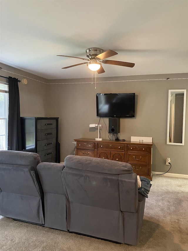 carpeted living room with ceiling fan