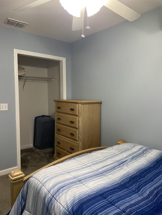 bedroom featuring a closet, dark colored carpet, and ceiling fan