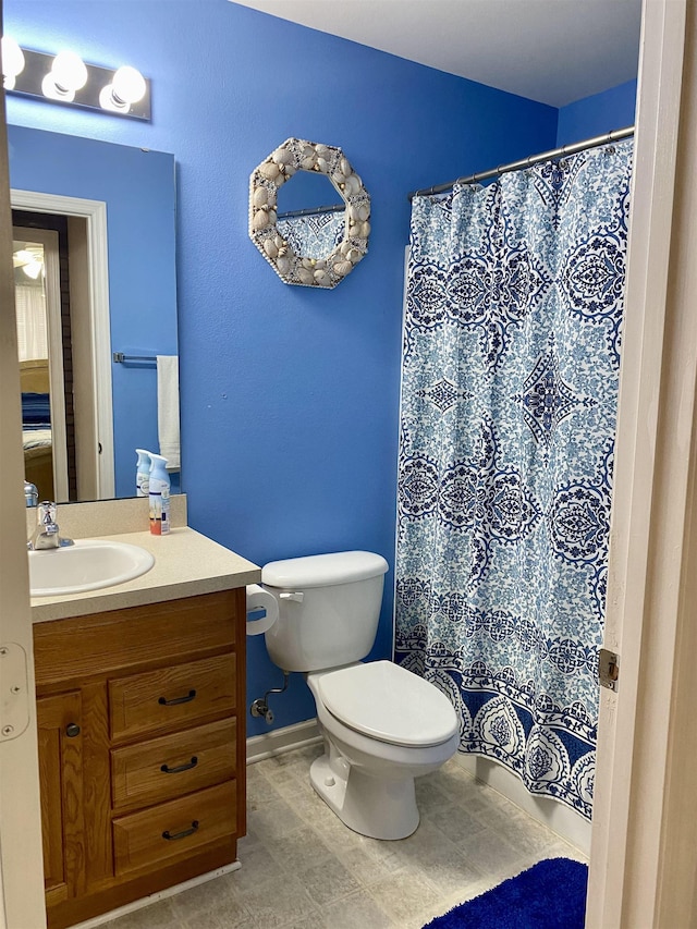 bathroom featuring toilet and vanity