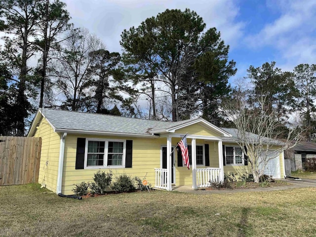 ranch-style home with a porch and a front yard