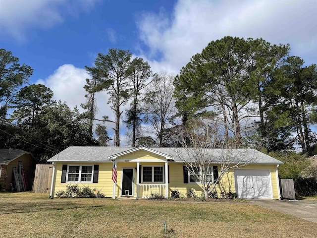 ranch-style house featuring a garage, a front yard, and a porch