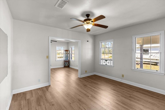 spare room with light hardwood / wood-style flooring and ceiling fan