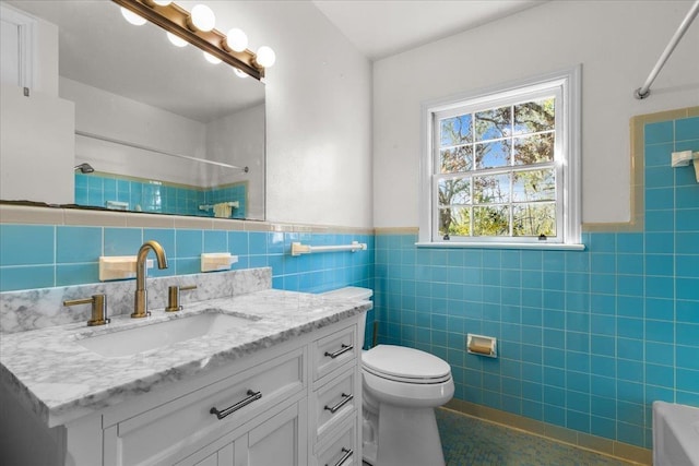 full bathroom with shower / bathing tub combination, vanity, tile walls, and toilet