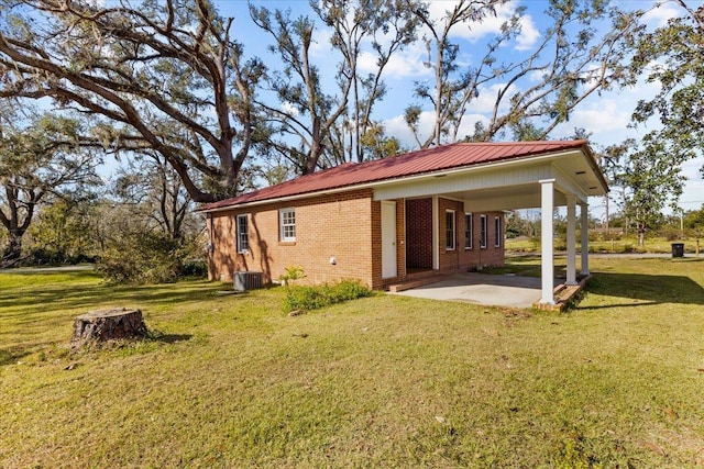 back of property with a lawn, a patio, and central AC unit