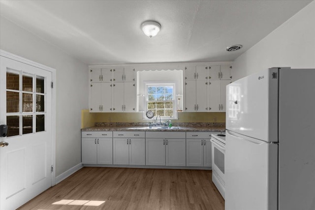 kitchen featuring white cabinetry, sink, light hardwood / wood-style flooring, a textured ceiling, and white appliances