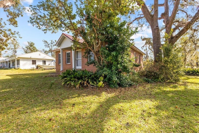 view of side of home featuring a lawn