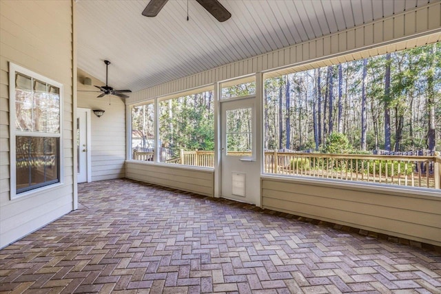 unfurnished sunroom featuring lofted ceiling and ceiling fan