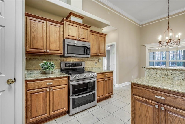 kitchen featuring light tile patterned flooring, light stone counters, crown molding, tasteful backsplash, and appliances with stainless steel finishes