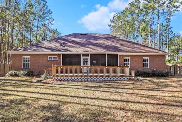 view of front of home featuring a wooden deck, a sunroom, and a front lawn