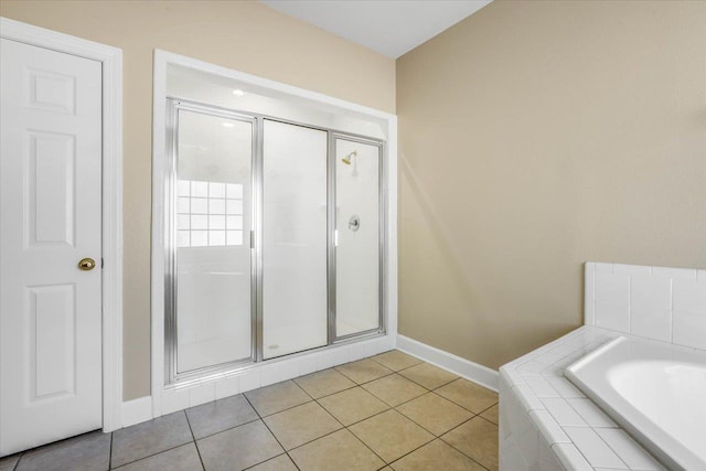 bathroom featuring shower with separate bathtub and tile patterned floors