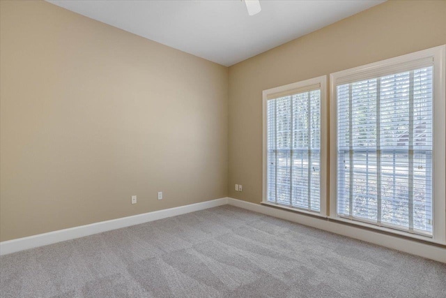 spare room with a healthy amount of sunlight and light carpet