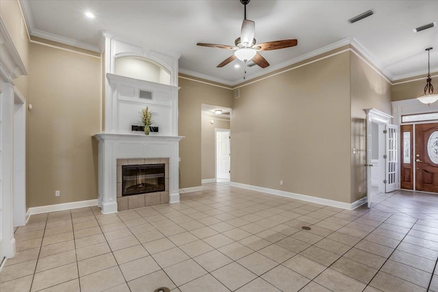 unfurnished living room featuring crown molding, light tile patterned floors, and a fireplace