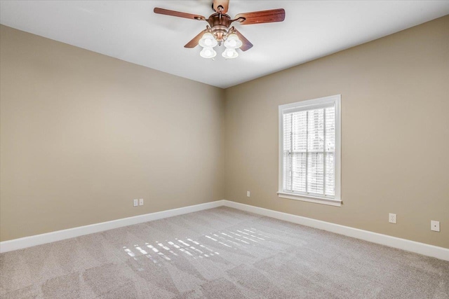 spare room with light carpet and ceiling fan