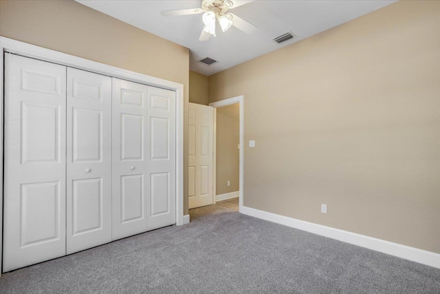 unfurnished bedroom with light carpet, a closet, and ceiling fan