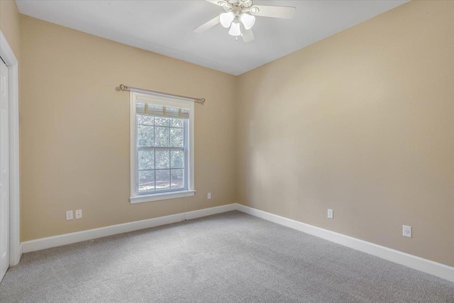 spare room featuring carpet floors and ceiling fan