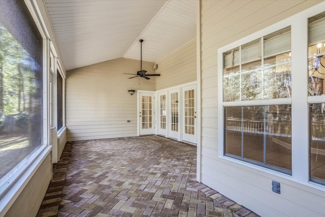 unfurnished sunroom with ceiling fan and lofted ceiling