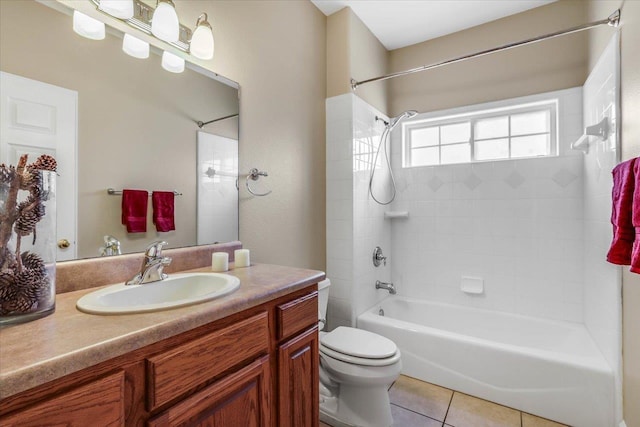 full bathroom with tiled shower / bath, tile patterned floors, toilet, and vanity