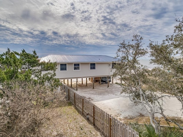 1171 Alligator Dr, Alligator Point, FL 32346 - rear view of house with metal roof and fence