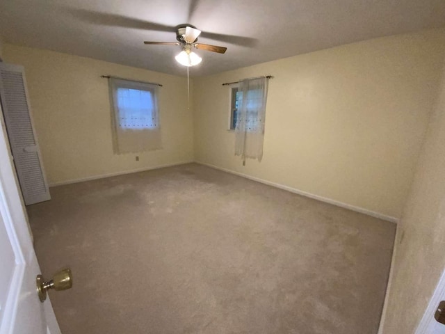 carpeted empty room with ceiling fan