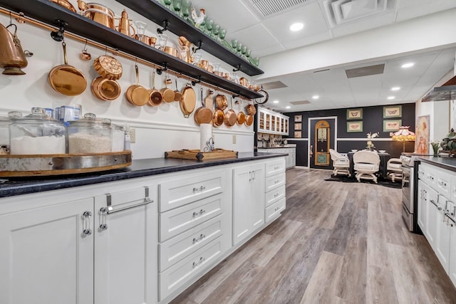 5902 Shady Rest Rd, Havana, FL 32333 - kitchen with electric stove, a paneled ceiling, dark countertops, white cabinets, and light wood finished floors