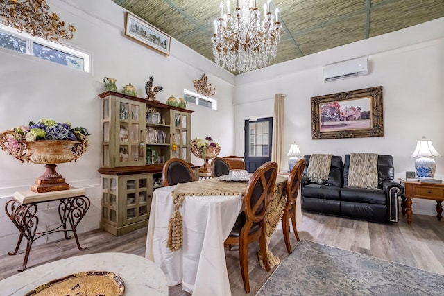 5902 Shady Rest Rd, Havana, FL 32333 - dining room with a wall unit AC, wood finished floors, a chandelier, and a towering ceiling