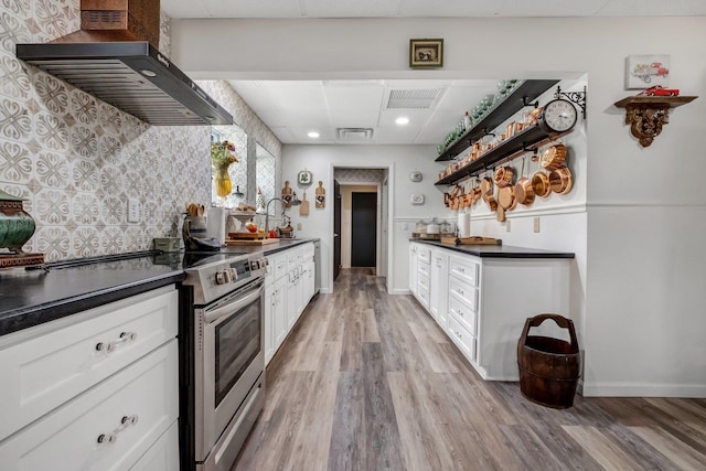 5902 Shady Rest Rd, Havana, FL 32333 - kitchen featuring wall chimney exhaust hood, stainless steel electric range, dark countertops, open shelves, and recessed lighting