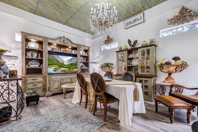 5902 Shady Rest Rd, Havana, FL 32333 - dining area featuring a chandelier, light wood-style flooring, and a high ceiling