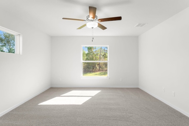 spare room featuring ceiling fan and light colored carpet