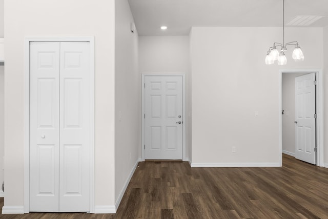 interior space featuring dark hardwood / wood-style flooring and an inviting chandelier