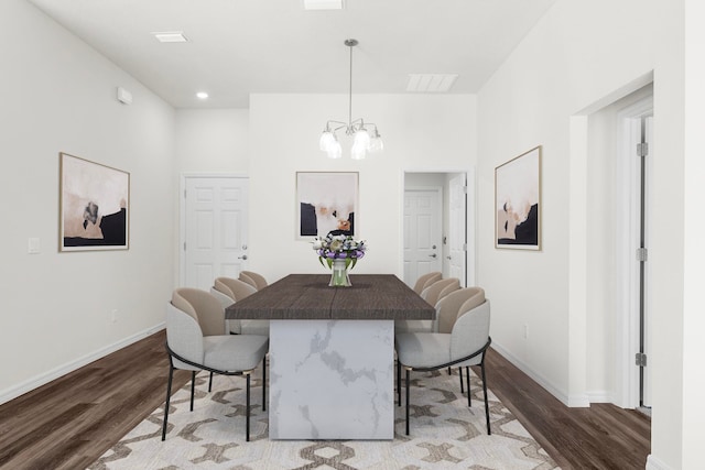 dining room with a chandelier and hardwood / wood-style flooring