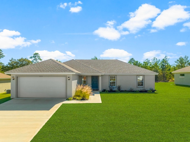 single story home with a garage and a front lawn