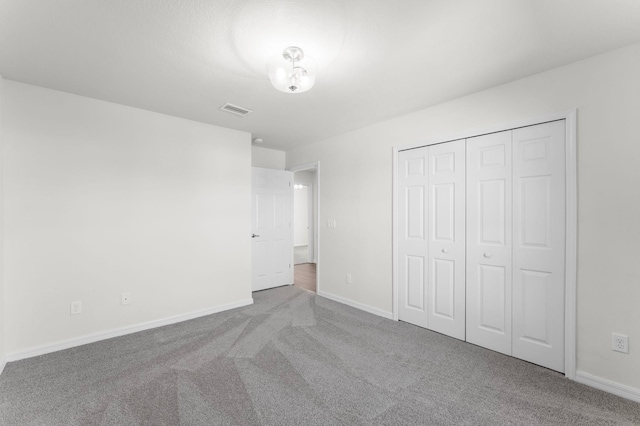 unfurnished bedroom featuring a closet and carpet