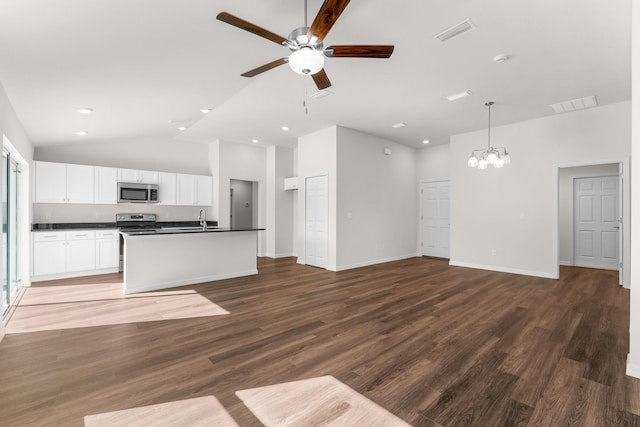 kitchen with white cabinets, a center island with sink, ceiling fan with notable chandelier, dark hardwood / wood-style floors, and stainless steel appliances