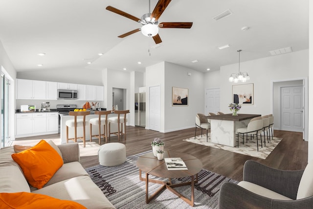 living room featuring dark hardwood / wood-style flooring, high vaulted ceiling, and ceiling fan with notable chandelier