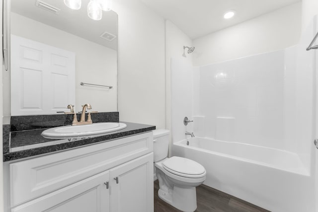 full bathroom featuring vanity, toilet, shower / bathing tub combination, and hardwood / wood-style flooring