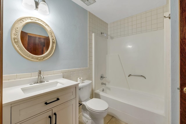 full bathroom featuring tile walls, vanity, tiled shower / bath combo, tile patterned flooring, and toilet