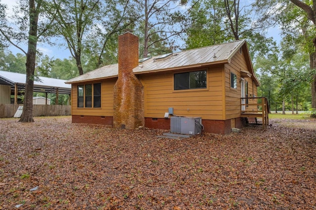 back of house with central AC