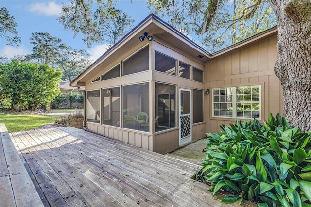 wooden deck with a sunroom