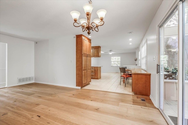 dining room with baseboards, visible vents, ceiling fan with notable chandelier, light wood-type flooring, and recessed lighting