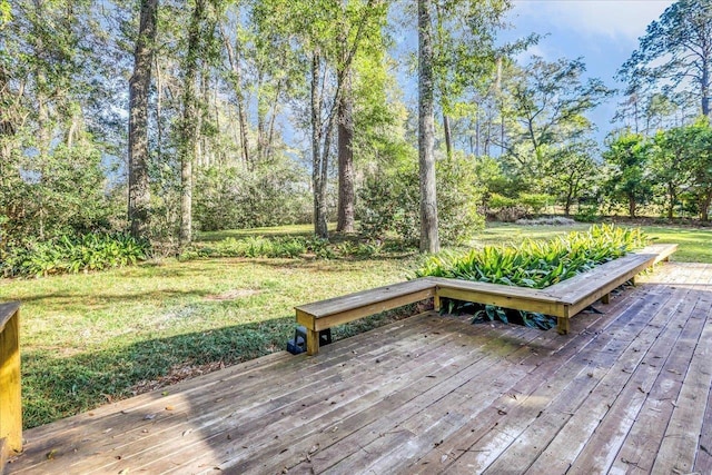 wooden terrace featuring a lawn