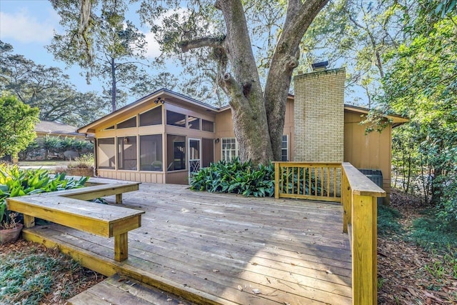 wooden deck featuring a sunroom