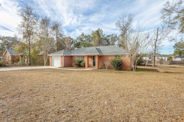 ranch-style house with a garage and a front yard